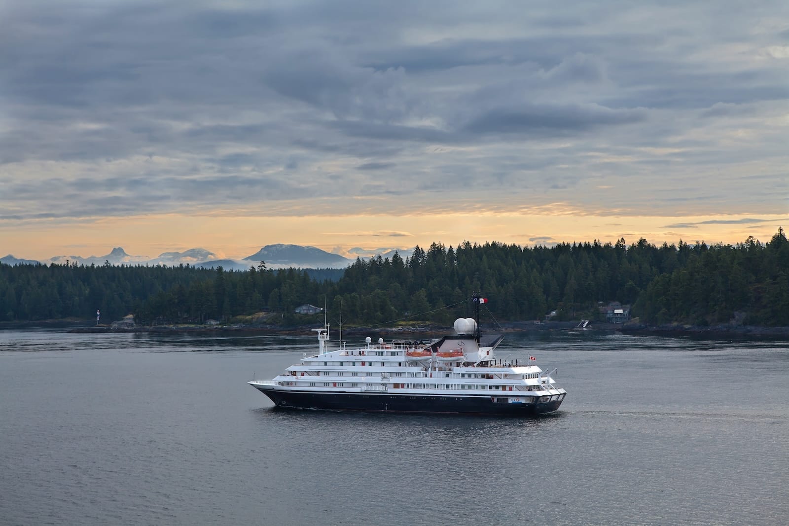 Small cruise ship in Alaska's Inside passage at sunset, Uncruise Adventures