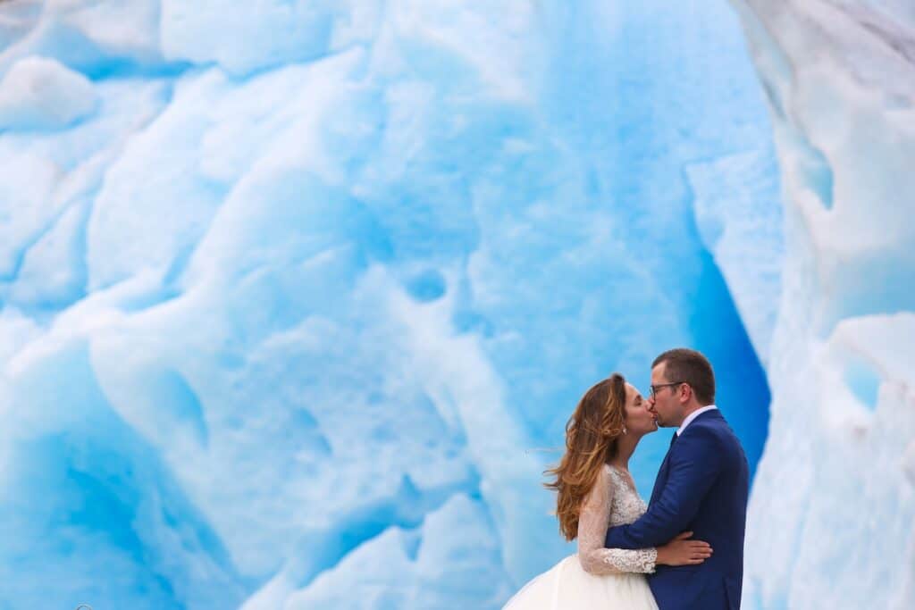 Wanting to elope in Alaska? It's one of the most romantic ways to say "I do!" Here is the easiest way to plan your Alaska elopement. groom and bride posing near glacier